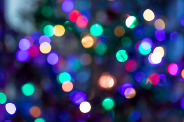Obraz na płótnie Canvas Sparkly multicolored Christmas lights of bright neon colors as festive background or wallpapers.