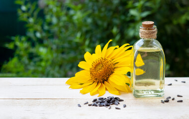 Close-up of sunflower oil in a bottle glass with seeds and sunflower