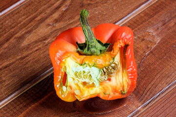 Red ripe sliced spoiled wrinkled sweet pepper