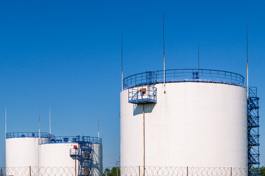 Vertical Steel Tank For Storing Petroleum Products And Flammable Liquids. A Park For Storing Petroleum Products. Lightning Protection Device On Tanks. Gasoline Production.