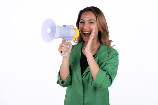 Young asian woman shouts into a megaphone. Isolated white background.