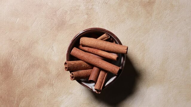 cinnamon sticks on a brown background