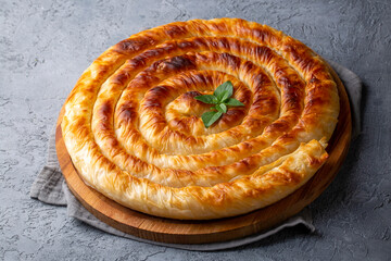 Traditional Turkish pastry with spinach. (Turkish Name: Ispanakli Kol Boregi, Bosnak boregi). Handmade pastry with spinach filling.