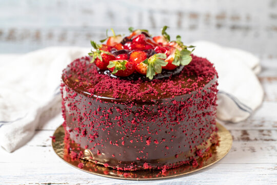 Fruit cake. Celebration or birthday cake on a white wood background. close up