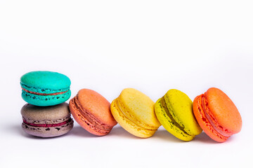 Colorful macaroon cakes. Small french muffins. Colorful macarons on a white background
