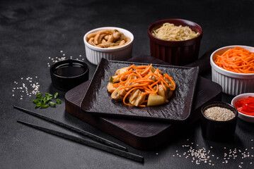 Tasty spicy Korean mushroom with spices and herbs on a dark concrete background