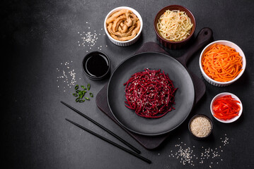 Tasty spicy Korean beet with spices and herbs on a dark concrete background