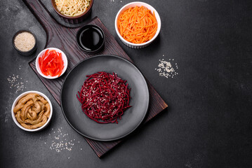 Tasty spicy Korean beet with spices and herbs on a dark concrete background