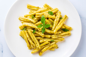 Casarecce pasta with cilantro pesto sauce on a grey background, top view. Delicious vegetarian lunch.