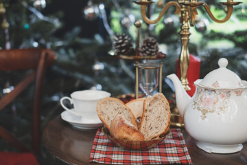 Christmas table setting with a freshly baked sliced festive cake with with vintage teapot, Concpet...