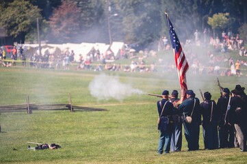 Confederate reenactors fire their rifles during the Civil War reenactment