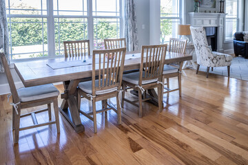 An open coastal dining room in a new construction house with hard wood floors