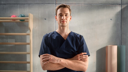Portrait of a Handsome Professional Male Nurse Standing and Posing for Camera, Smiling in Medical...