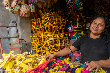 Latina woman seller of traditional Masaya crafts, used for the celebration of la purisima or...