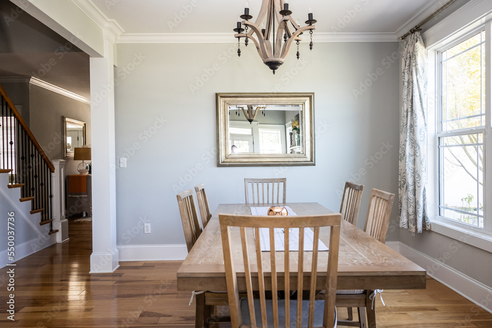 Wall mural an open coastal dining room in a new construction house with hard wood floors