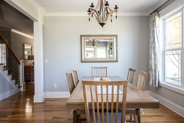 An open coastal dining room in a new construction house with hard wood floors