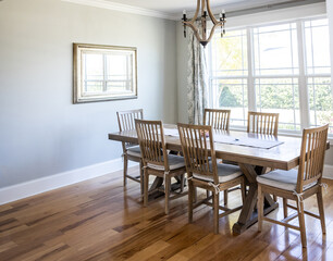 An open coastal dining room in a new construction house with hard wood floors
