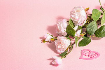 Blooming roses on a branch, a heart with the word 