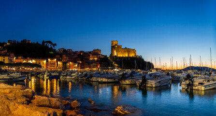 Naklejka premium The village of Lerici by night with a view of the port and the medieval castle Lerici Italy