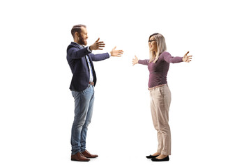 Fototapeta premium Full length profile shot of a young man and woman meeting with arms wide open