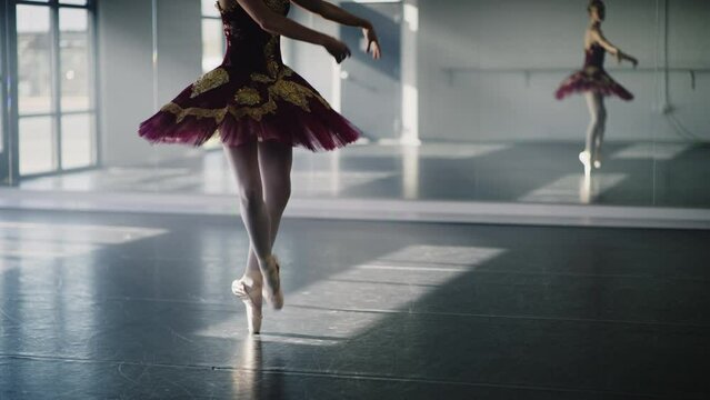 Legs of ballerina practicing dancing en pointe in dance studio / Lehi, Utah, United States