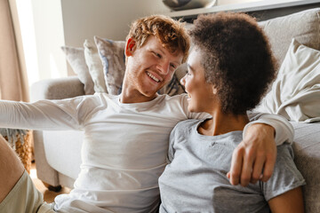 Young beautiful happy smiling interracial couple looking at each other