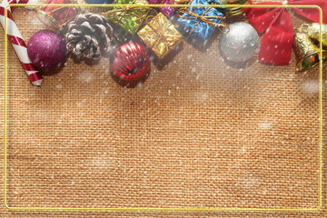Christmas balls,bell,box,present cane,pine cone,ribbon,bell on sackcloth with copy space ,top view