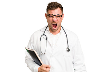 Young doctor caucasian man holding a book isolated screaming very angry and aggressive.