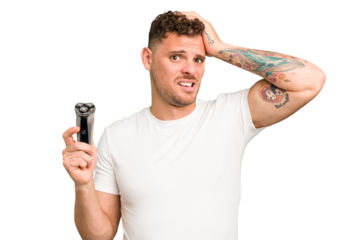 Young caucasian man holding a razor isolated being shocked, she has remembered important meeting.