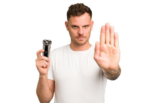 Young caucasian man holding a razor isolated standing with outstretched hand showing stop sign, preventing you.