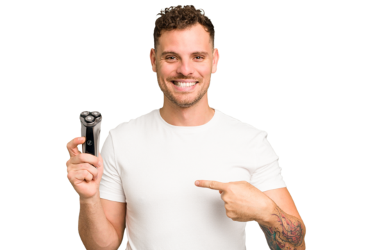 Young caucasian man holding a razor isolated person pointing by hand to a shirt copy space, proud and confident