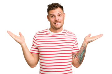 Young caucasian handsome man isolated confused and doubtful shrugging shoulders to hold a copy space.