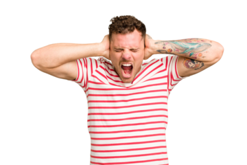 Young caucasian handsome man isolated covering ears with hands trying not to hear too loud sound.