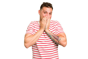 Young caucasian handsome man isolated laughing about something, covering mouth with hands.