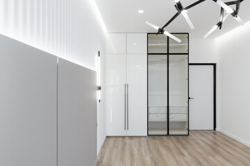 a large, spacious, bright room with a wardrobe and a mirror