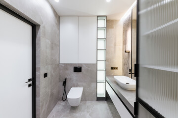 Fototapeta na wymiar modern bathroom interior design with lighting and gray tiles
