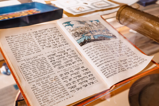 28 July 2022, Essen, Germany: The Jewish holy book of the Torah with the text in Hebrew and in German in the museum in the synagogue