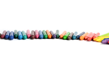 Crayons lined up isolated on white background.