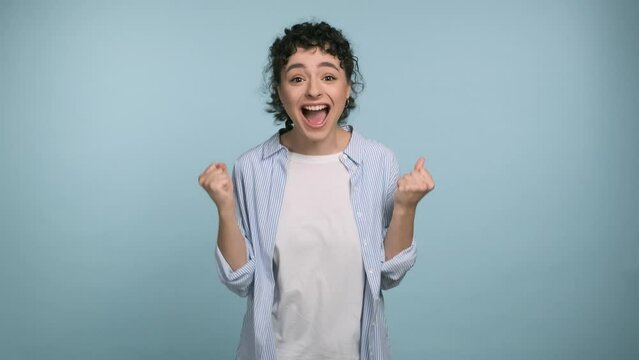Oh my god wow. Cheerful woman very glad, she screaming loud. Amazed excited happy lady on blue studio background. Concept of win lottery, sales, profitable offer