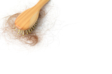 Brown hair loss and comb, hair loss every day, serious problems and hair loss on a white background.	
