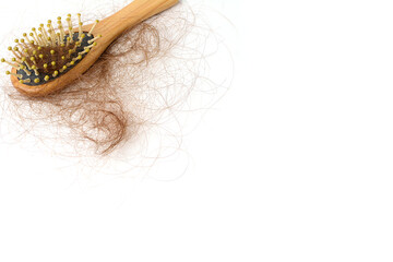 Brown hair loss and comb, hair loss every day, serious problems and hair loss on a white...