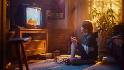 Fototapeta na wymiar Nostalgic Retro Concept: Young Boy Playing Old-School Eighties Arcade Video Game on a Console at Home in His Room with Period-Correct Interior. Successful Kid Passes the Level and Wins.