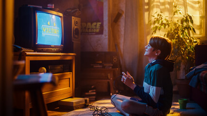 Young Boy Playing Eighties 2D Arcade Space Shooter Game on a Gaming Console at Home in His Room with Old-School Interior. Child Successfully Wins Level. Nostalgic Retro Childhood Concept.