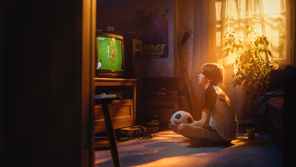 Young Sports Fan Watches a Soccer Match on TV at Home. Curious Boy Supporting His Favorite Football Team, Feeling Proud When Players Score a Goal. Nostalgic Retro Childhood Concept.