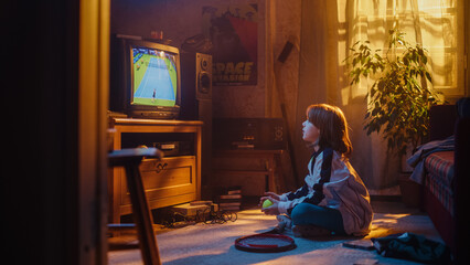 Fototapeta na wymiar Nostalgic Retro Childhood Concept. Young Girl Watches a Tennis Match on TV in Her Room with Dated Interior. Supporting Her Favorite Player, Getting Excited While Watching an Important Game.