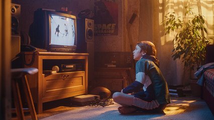 Nostalgic Retro Childhood Concept. Young Boy Watches Hockey Match on TV in His Room with Dated Interior. Supporting His Favorite Team, Being Focused on His Favourite Player in Action.