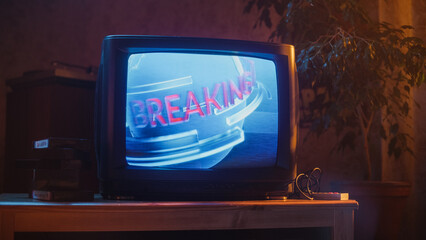 Close Up Footage of a Dated TV Set Screen: Breaking News Report. Intro with Word Breaking Revolving...