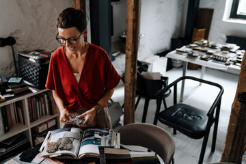 European brunette woman working with interior samples in office
