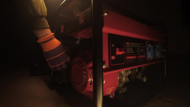 Gasoline electricity generator. Man starts a gasoline emergency Generator.