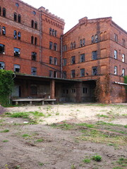 Old weathered and defunct factory building in red brick, Magdeburg, Germany - 550050785